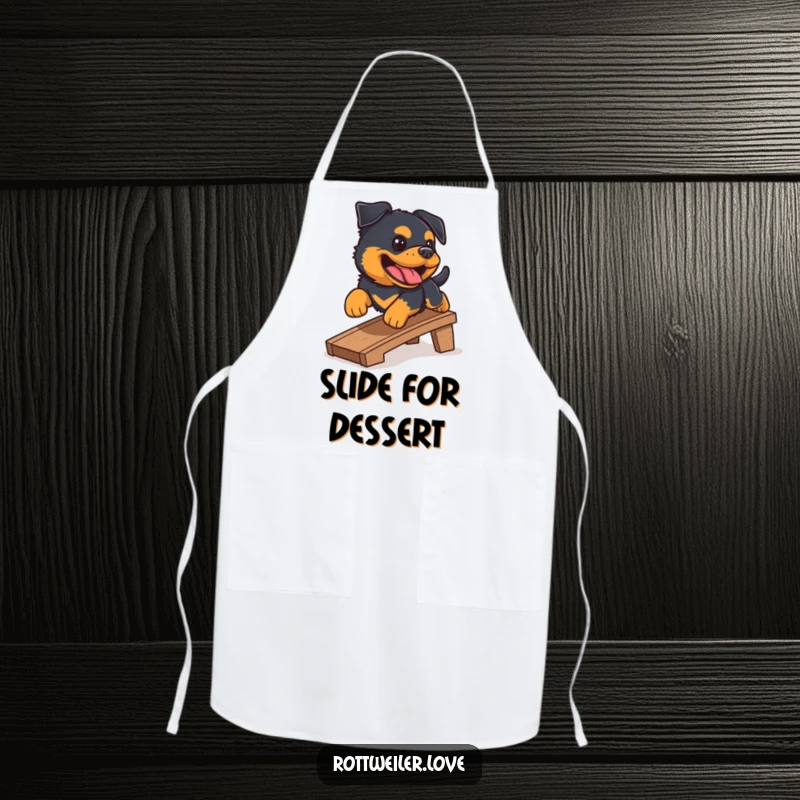 Funny Rottweiler apron with a happy Rottweiler mid-slide down a small ramp, mid-bark. Great for kitchen fun.