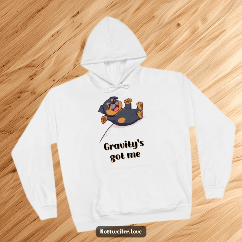 Funny Rottweiler hoodie depicting a dog joyfully sliding on its back with its paws up, embodying pure canine bliss.
