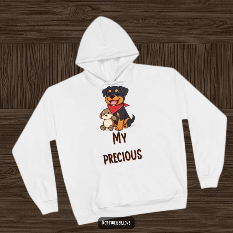 Funny rottweiler hoodie with a joyful dog wearing a bandana, guarding a plush toy, offering cozy humor and protection.