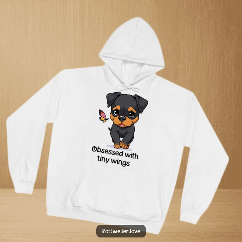 Funny Rottweiler hoodie showcasing a dog with a determined expression, intently chasing a butterfly, perfect for staying warm and motivated.