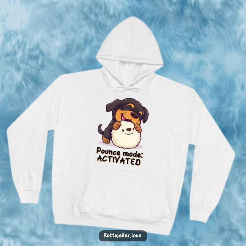 Funny rottweiler hoodie illustrating a dog hilariously pouncing on a plush toy, emphasizing playful action and warmth.