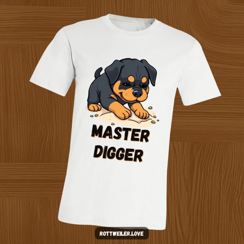 Funny Rottweiler t-shirt with a dog enthusiastically digging in soft sand, embodying playful energy and outdoor fun.