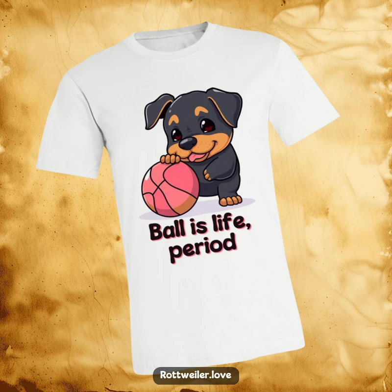 Funny Rottweiler t-shirt showing a dog actively nudging a large, bouncy ball, capturing the spirit of energetic and joyful play.