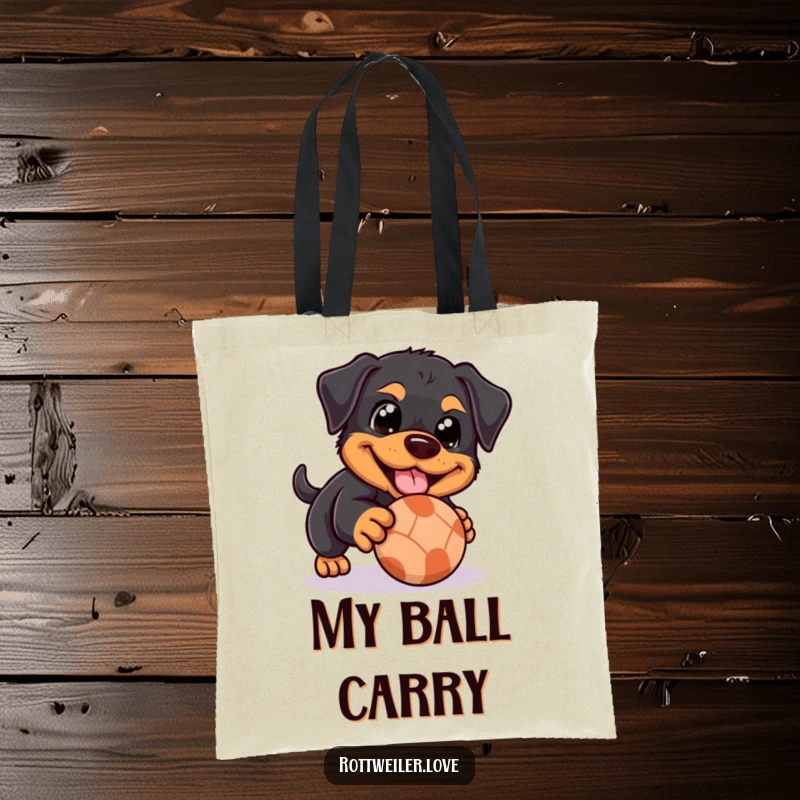 Funny Rottweiler tote bag showing a dog with happy eyes playfully nudging a rolling ball, a charming and practical accessory for dog lovers.